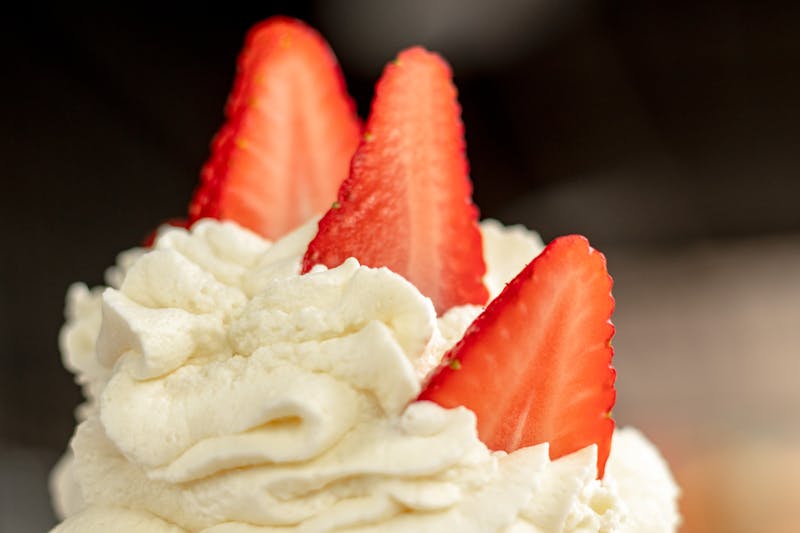 Chuys classic tres leches cake with whipped cream and strawberries